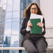 Businesswoman standing outdoors in city office building backgrou